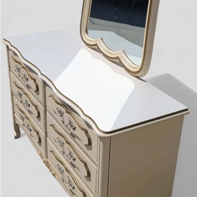 Bring timeless design into your home with this French Provincial dresser in a classic cream and gold finish. Design...