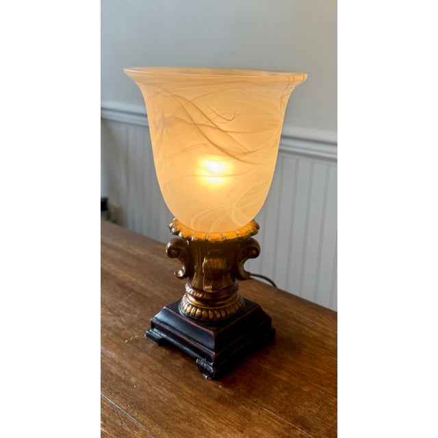 This is a classic elegant Torchiere table lamp featuring a frosted marbled look, bell shaped glass shade which directs...