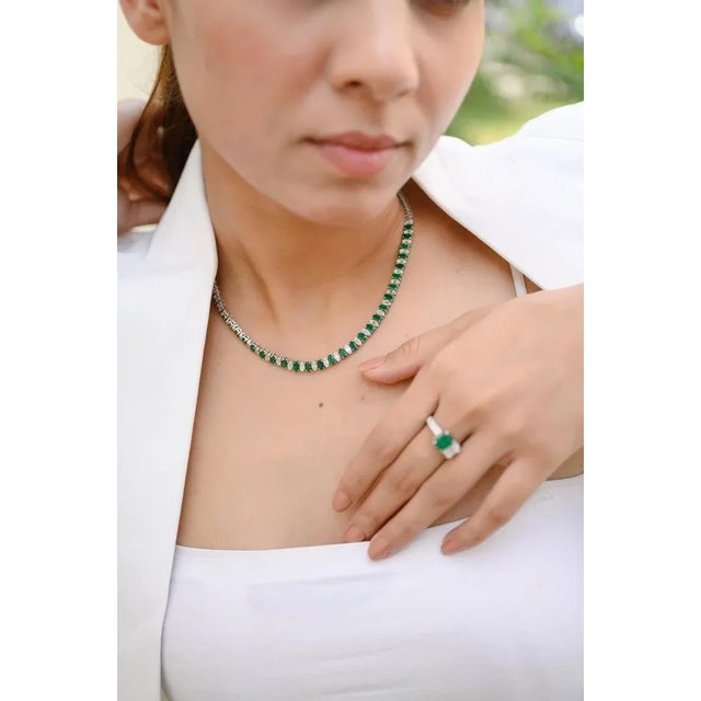 Genuine Emerald Diamond Tennis Necklace in 18K Gold set with oval cut emeralds and mixed cut diamonds. This gorgeous piece...