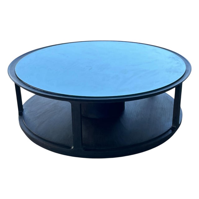 This modern round coffee table by Dunbar reflects the refined proportions and architectural design associated with mid-...