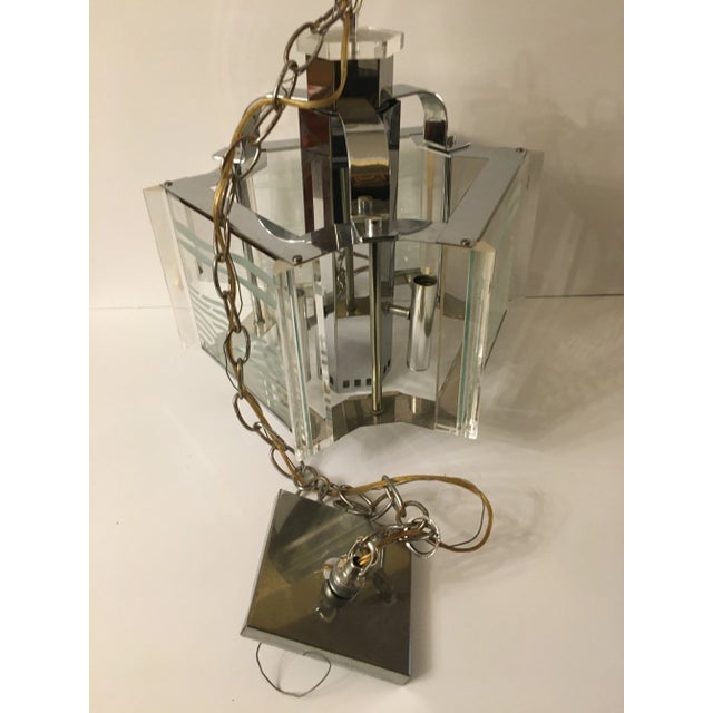 Dated 1985 this Signed Frederick Raymond pendant fixture features Etching on glass, chrome and plexiglass Was made in...