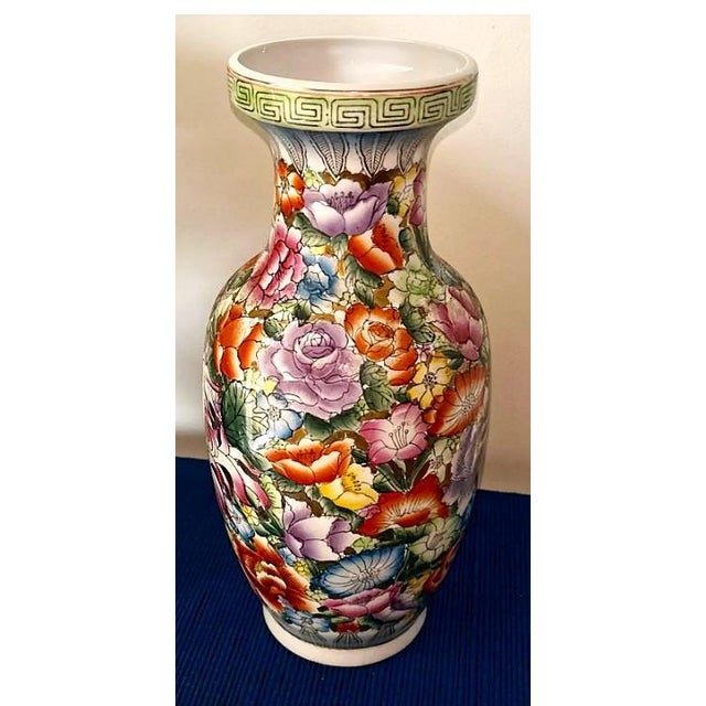 This striking 16-inch porcelain vase features a beautifully hand‑painted Famille Rose floral design in vivid shades of...