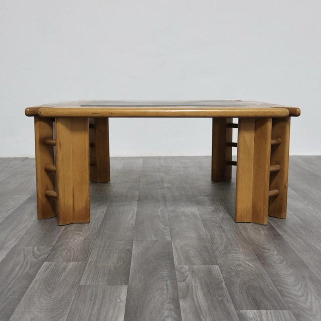 This elegant 1960s coffee table, crafted entirely of wood, perfectly embodies the distinctive design of the period. Its...