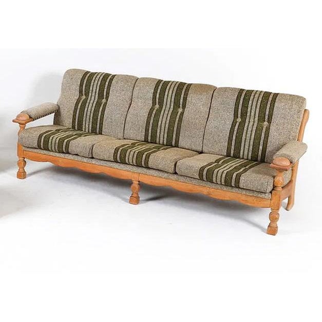 A Danish modern sofa with a figured oak frame, orb type armrests, with striped upholstered cushions. Understated, simple,...