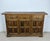 Beautiful Spanish sideboard crafted in solid walnut, featuring three upper drawers above three paneled cabinet doors with...