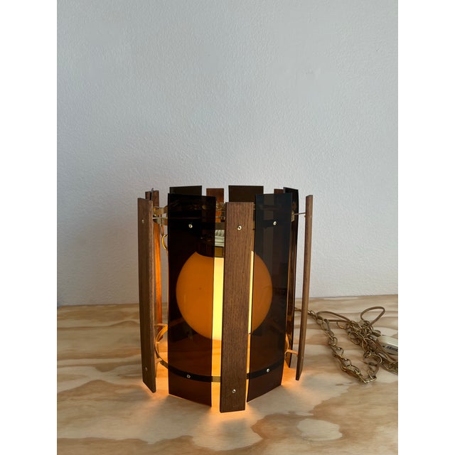 Add a touch of vintage charm to your space with this unique MCM Swag Lamp Light. The smoked lucite and wood panels give it...