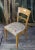 A classic pair of French 1940s side chairs with embroidered seats. This pair of French 1940s side chairs is an exquisite...