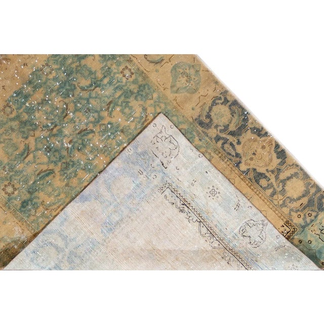 Beautiful vintage Distressed Turkish hand-knotted wool rug with a turquoise field. This piece has tan, gray and brown...