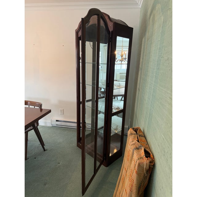 Elegant Pulaski illuminated curio cabinet in excellent condition, showcasing classic traditional design and refined...