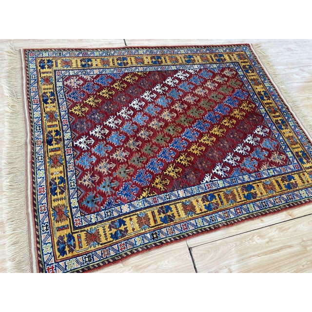 This vintage rug is hand-knotted in wool, woven in the Shirvan Caucasian tribal design tradition. Measuring 5'1" x 6'7"...