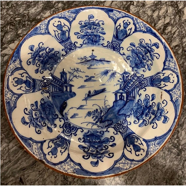 Great 18th century hand painted Dutch delft chinoiserie decorated platter. 13.25” diameter. Hole drilled for wall mounting.