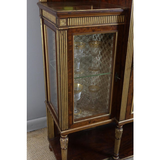 Louis xvi style serving display case with three doors and shelves. This piece of furniture is very carefully crafted and...