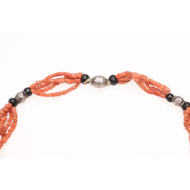 A truly unique Afghan statement necklace made from antique coral beads and metal charms. There are coin and silver charms...