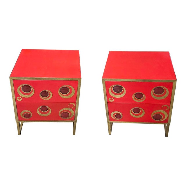 Beautiful pair of bedside tables entirely handmade; wooden structure covered in red glass, enriched by a tubular brass...