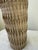 Vintage ceramic in heavy textured neutral tones, used as decorative object or vase.