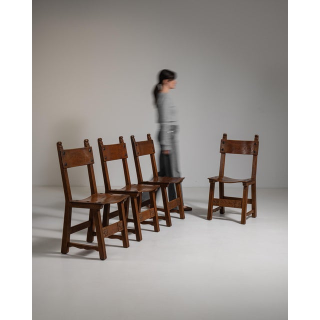 Rendered in richly grained French oak, this striking set of four dining chairs exemplifies the Brutalist aesthetic that...