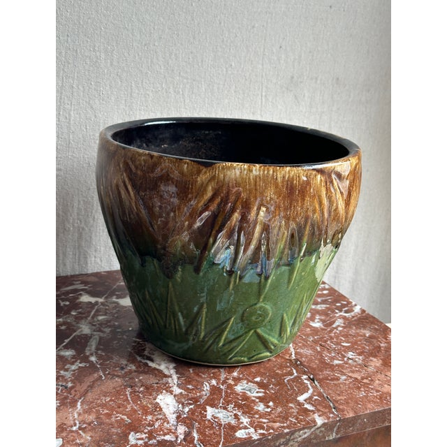 This RRP Art Deco Pottery Sun & Moon Planter is glazed with a distinctive majolica style green and brown drip glaze. It...