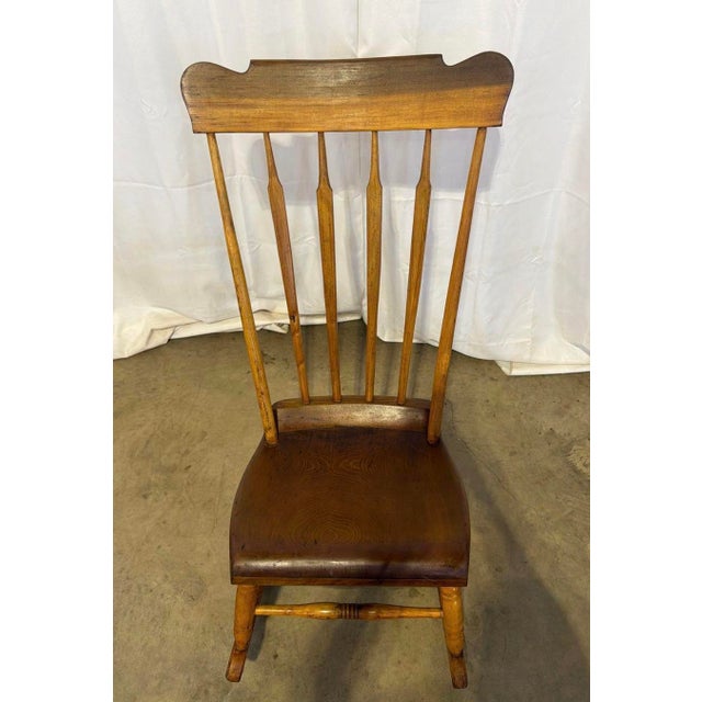 Antique Mid-19th Century Arrow Back Windsor Style Nursing Rocking Chair. It has plank bottom seat. It measures 39”Hx 17...
