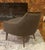 Mid-Century Modern chair accented with a wood boomerang detailing the timeless dark olive dense boucle textile, ready to...