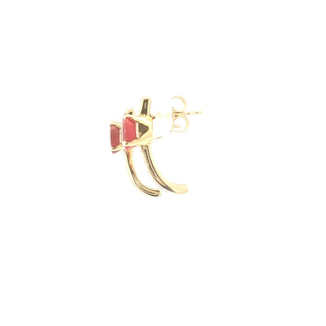 A pair of ruby and diamond drop earrings in 18k gold. Each earring features an oval-cut red ruby, accented by princess-cut...