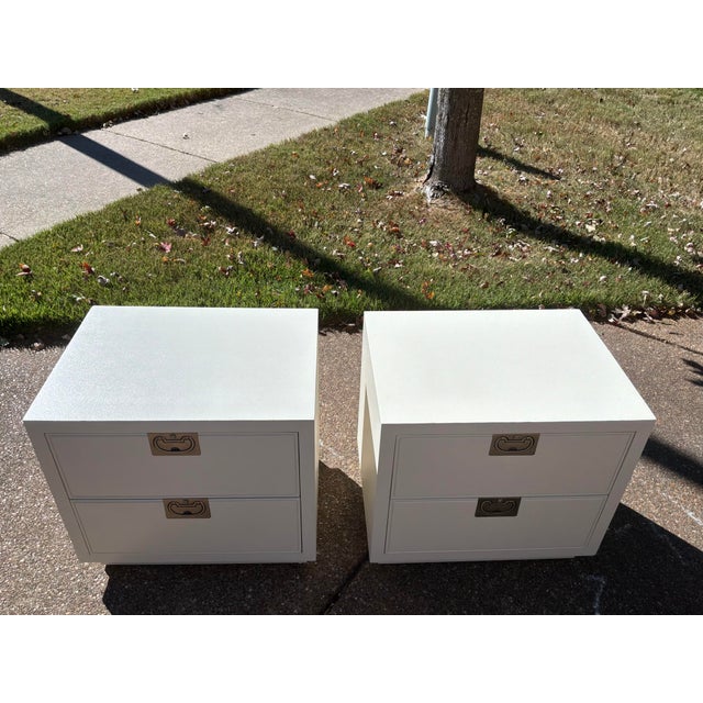 This is a striking vintage pair of campaign-style nightstands from the celebrated "Bel Air" collection by luxury maker...