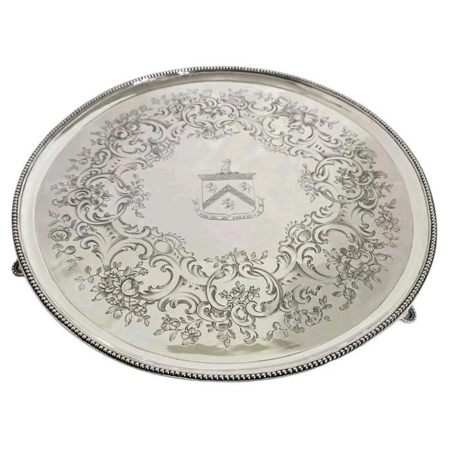 An exceptional george iii sterling silver salver or waiter dating to 1785, displaying the refined craftsmanship and...
