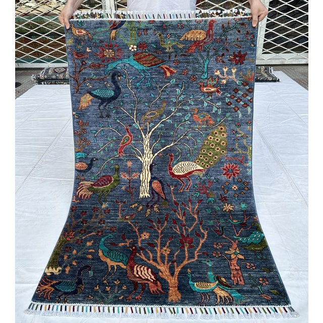 Persian Tree of Life design hand-knotted rug featuring a flourishing pictorial scene of regal peacocks and exotic birds...