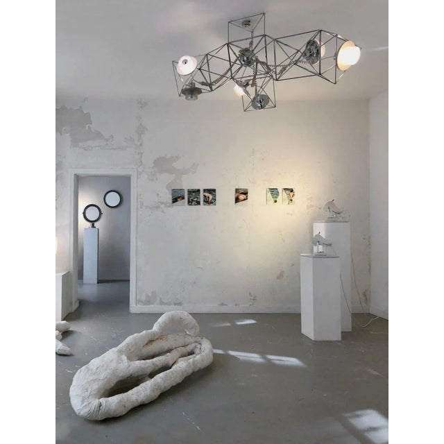 A spectacular and iconic modular suspension, of architectural and spatial inspiration, with 3 "arms" of light, and 6 light...