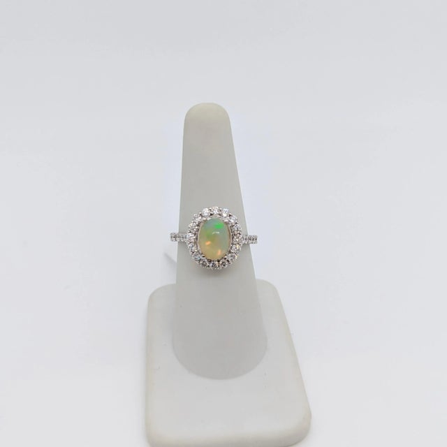 Beautiful 1.58 ct. opal oval cabochon with 0.97 ct. good quality white diamond rounds. Handmade in 14k white gold. Ring...