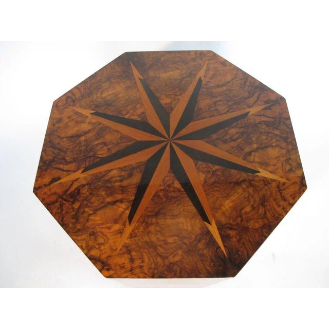 A rare eight sided table by Andrew Szoeke. Made of walnut and exotic wood veneer inlays on top forming a sunburst pattern.