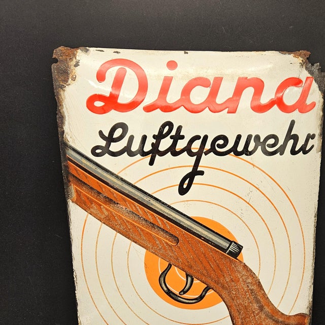Diana Air Rifle Advertising Sign in Enamel, 1940s, in Worn conditions. Designed 1920 to 1949 This piece has an attribution...