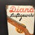 Diana Air Rifle Advertising Sign in Enamel, 1940s, in Worn conditions. Designed 1920 to 1949 This piece has an attribution...