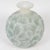 “Ormeaux” vase in pressed molded opalescent glass, enhanced with a blue-green patina. Model designed by René Lalique in...