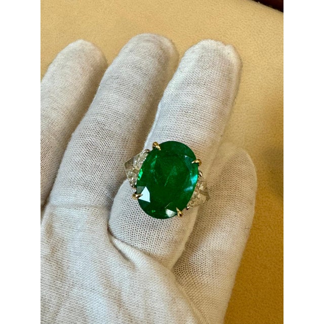 A classic, cocktail / Engagement ring GIA Certified 11 Ct Fine Oval Zambian Emerald & GIA Certified 1.52 Ct Each Trillion...