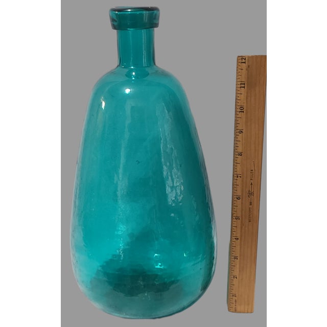 Crafted with a keen eye for style and a consciousness for recycling, this Vintage Large 14.75'' High Aqua Blue Glass...
