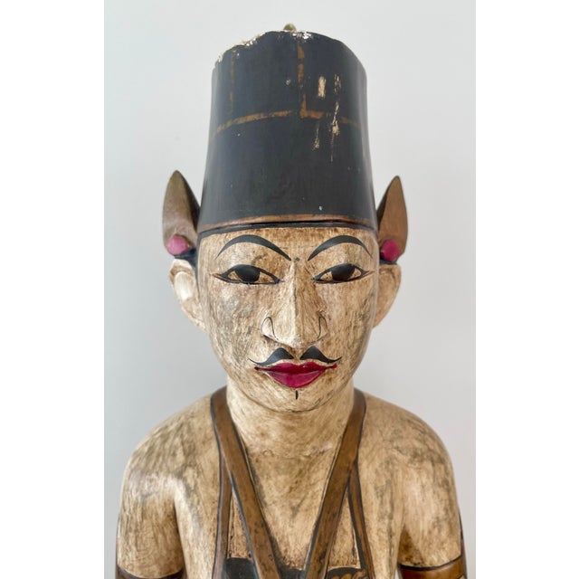 A striking and authentic pair of traditional Javanese Loro Blonyo figures, hand-carved from solid wood and richly...