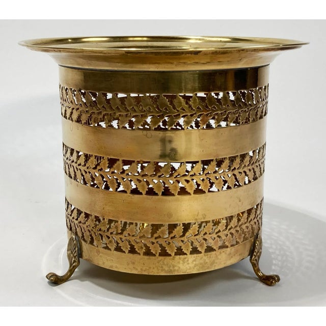 Beautiful vintage brass planter with a leaf pattern perforation. Planter sits on three lion paw feet. Alternative use as a...