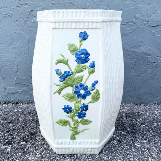 Charming vintage ceramic garden stool featuring a crisp white glazed body decorated with dimensional hand-painted cobalt...