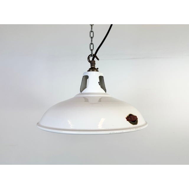 Industrial white enamel factory pendant light made by Thorlux in United Kingdom during the 1960s. White enamel inside the...