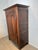 Authentic antique wardrobe in solid oak featuring beautifully shaped panel doors and original iron hardware. The cabinet...