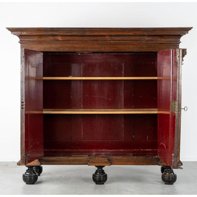 Dutch Renaissance cabinet / kas in sculpted oak, featuring a two-door facade framed by pilasters with carved Corinthian...
