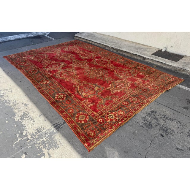 Design Plus Gallery presents a 9ft 2in x 14ft 2in Area Rug. The rug has a rustic red pattern with stylized motifs in rich...