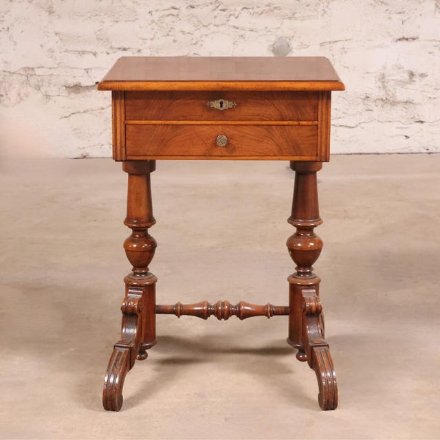This 20th Century English Double Pedestal Sewing Table is a thoughtfully designed antique that blends traditional...