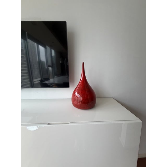 Stunning large hand-blown art glass vase in a rich ruby red tone with subtle black speckled inclusions. Elegant teardrop...