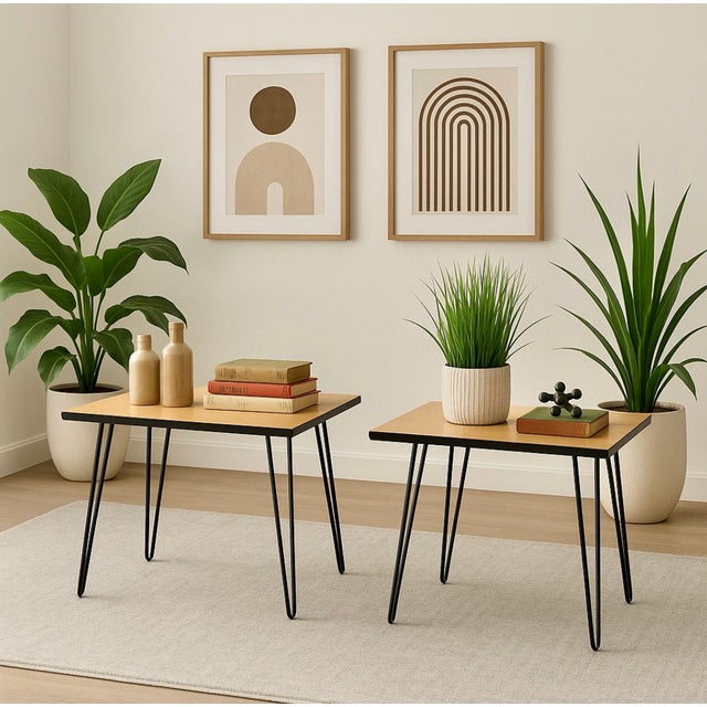 This striking pair of Mid-Century Modern side tables features sleek tall hairpin legs and durable wood laminate tabletops,...