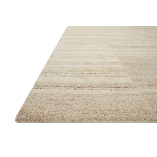 The Rocky Collection area rug by Amber Lewis x Loloi is uniquely hand-tufted with undyed wool to create a subtle and...