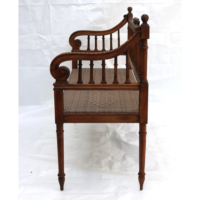 Stunning hand-carved bench or settee done in Louis XVI style. It features a strong faux cane resin seat and rich ornaments...
