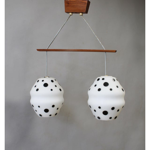 Unusual double pendant light produced in Czechoslovakia during the 1960s, featuring two sculptural white opaline glass...