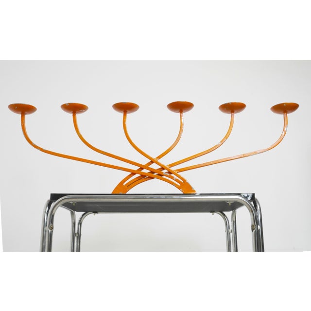 Large 1970s orange metal candelabra with a bold mid century modern statement design with strong Space Age influence. The...