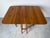 Beautiful and versatile, this vintage American drop-leaf dining table is crafted from solid cherry wood, showcasing warm...